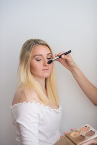 make-up being applied during preparations for photos shoot, illustrating the make-up tips article