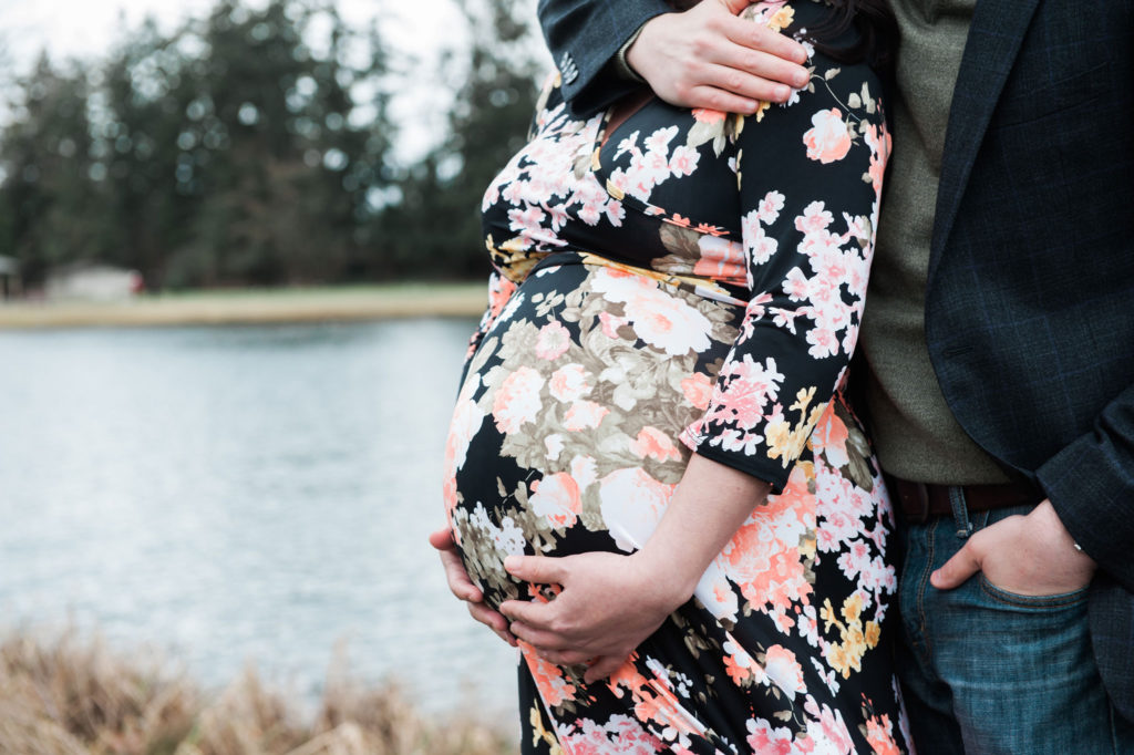 Outdoor maternity portrait session by the river with floral dress photographed by Tacoma Maternity Photographer Amanda Howse