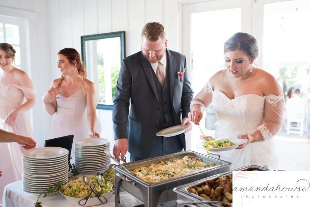 Bride and Groom Serving themselves at the Buffet for Genesis Farm and Gardens Wedding Reception