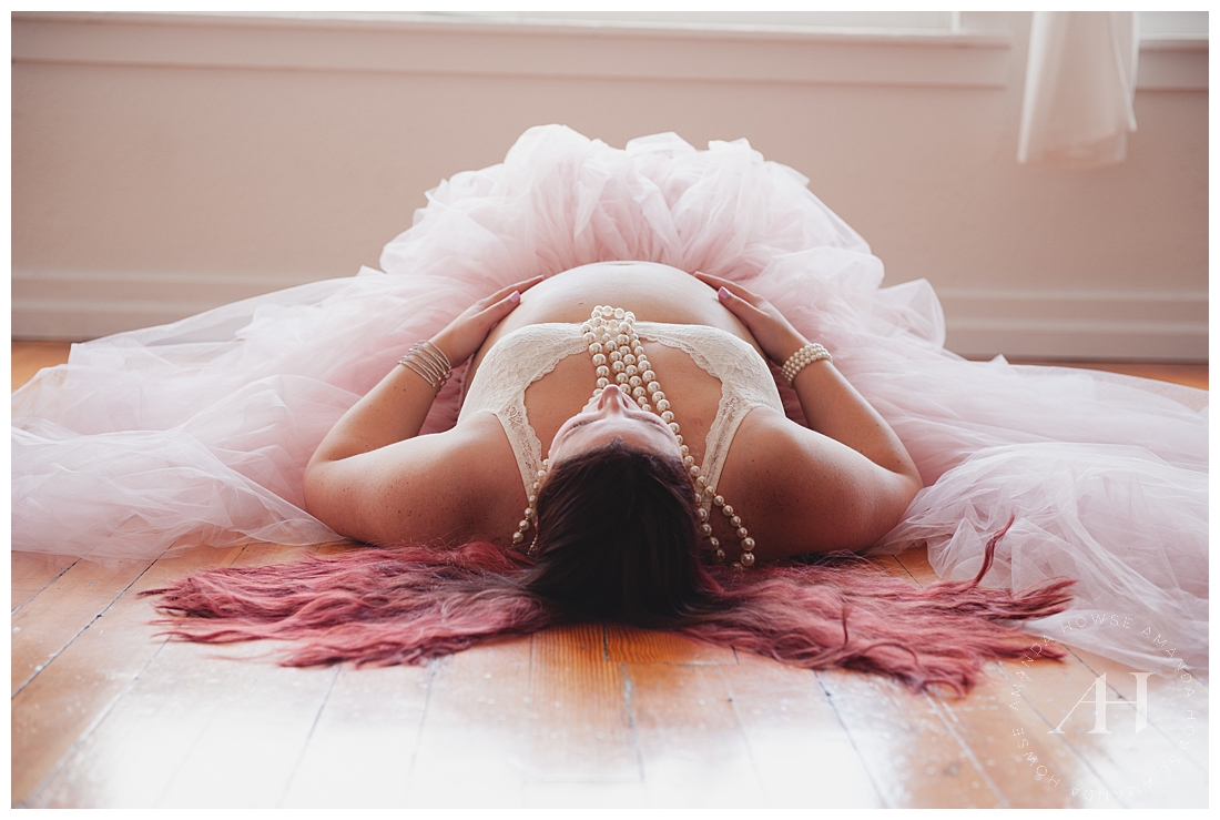 Pose Ideas for Maternity Photos | Pregnant Mama Laying on Floor in Pink Tutu and Pearls | Photographed by Tacoma Photographer Amanda Howse