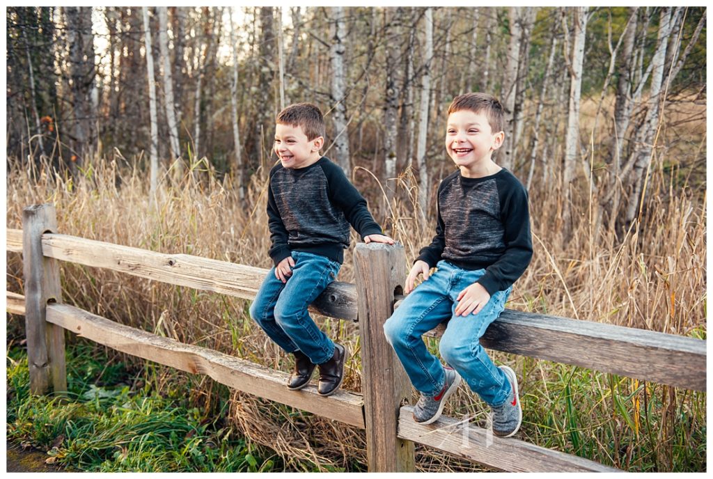 Twin Boys Sitting on a Rustic Fence at Fort Steilacoom | Photographed by the Best Tacoma Family Photographer Amanda Howse Photography